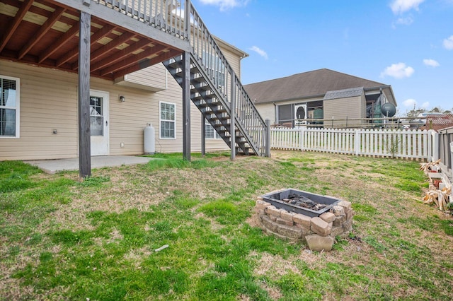 view of yard featuring a patio, an outdoor fire pit, stairway, and a fenced backyard