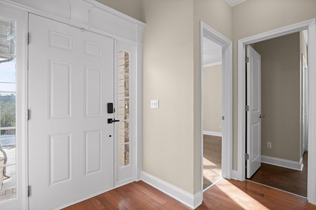 foyer entrance with hardwood / wood-style flooring and baseboards