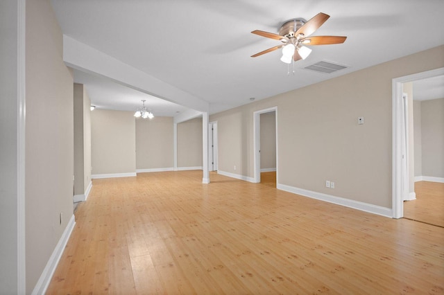 interior space with light wood finished floors, baseboards, visible vents, and ceiling fan with notable chandelier