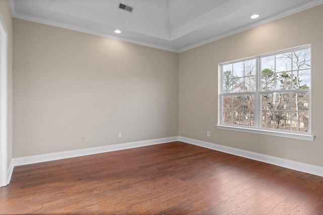 unfurnished room with plenty of natural light, visible vents, dark wood finished floors, and baseboards