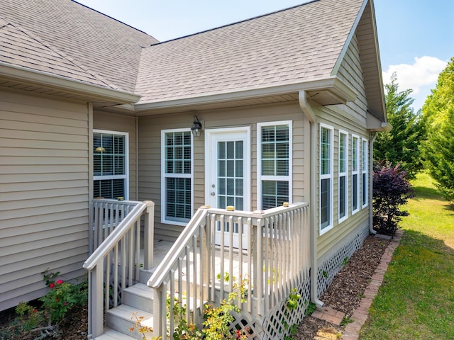 property entrance with roof with shingles