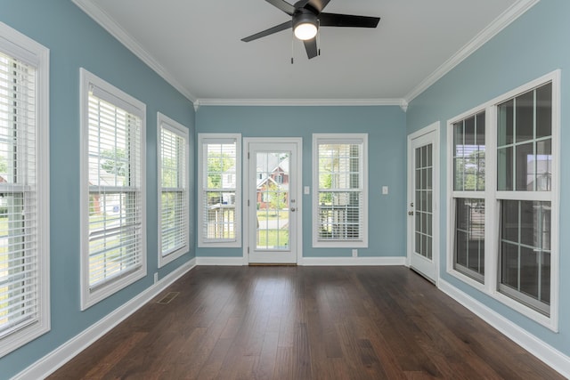 unfurnished sunroom with baseboards, ornamental molding, wood finished floors, and visible vents