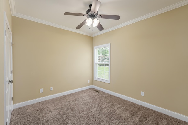 carpeted spare room featuring baseboards, ornamental molding, ceiling fan, and visible vents