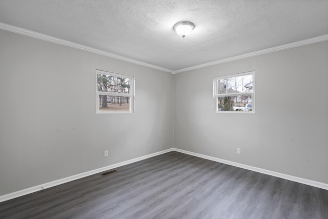 empty room featuring ornamental molding, a textured ceiling, and dark hardwood / wood-style flooring