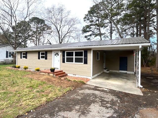 single story home featuring a carport