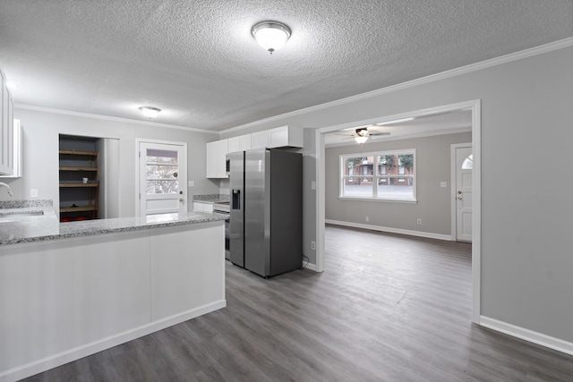 kitchen featuring white cabinetry, sink, stainless steel fridge, and kitchen peninsula