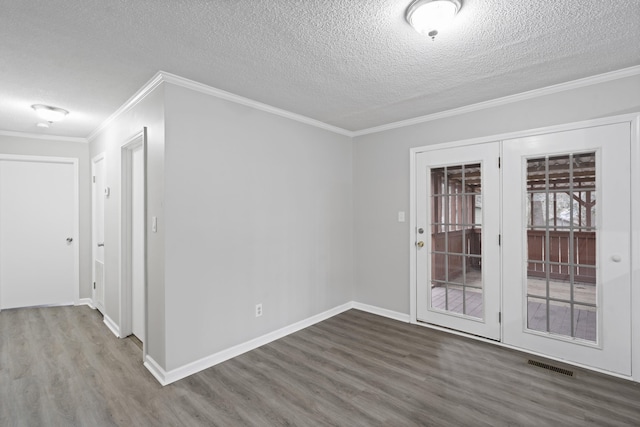 spare room featuring hardwood / wood-style flooring, crown molding, a textured ceiling, and french doors