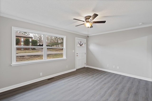 spare room featuring wood-type flooring, crown molding, ceiling fan, and a textured ceiling