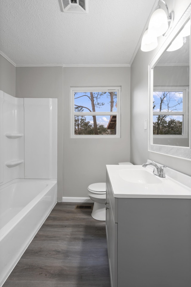 full bathroom with hardwood / wood-style flooring, vanity, a textured ceiling, and toilet