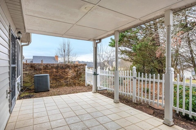 view of patio / terrace with cooling unit and fence