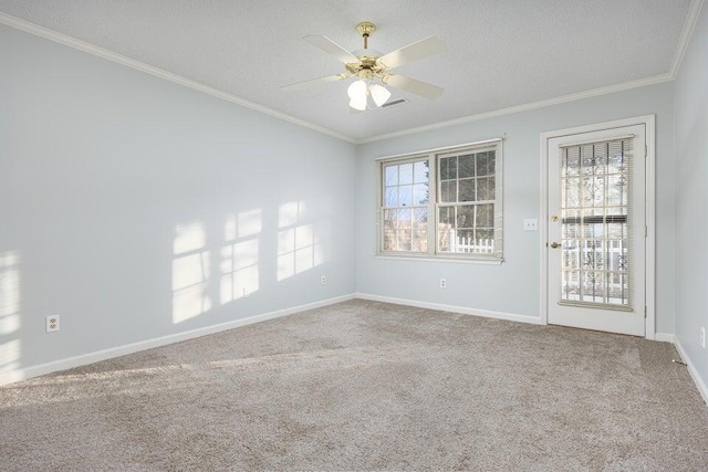 carpeted empty room with crown molding, a textured ceiling, baseboards, and ceiling fan