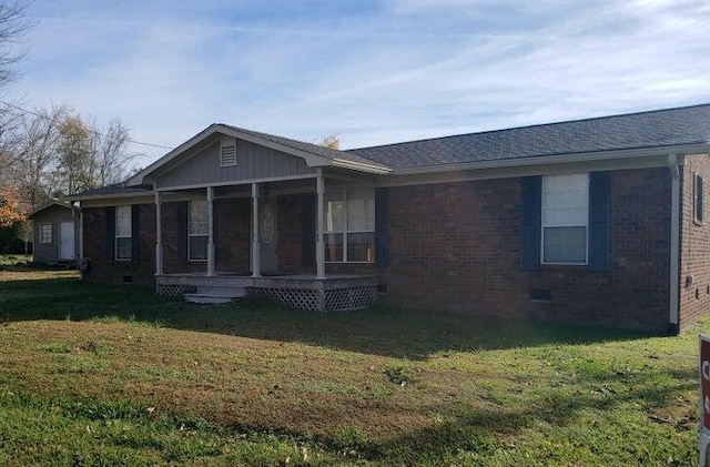 ranch-style house featuring a sunroom and a front lawn