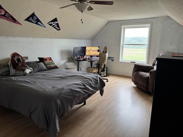 bedroom featuring vaulted ceiling, light hardwood / wood-style flooring, and ceiling fan