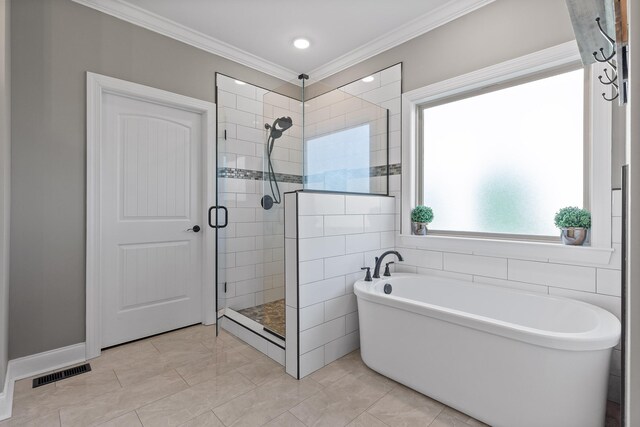 bathroom featuring tile patterned flooring, ornamental molding, and independent shower and bath