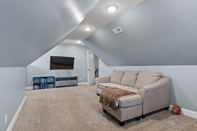 carpeted living room with lofted ceiling