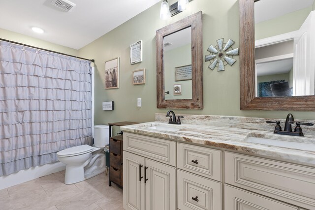 full bathroom featuring tile patterned flooring, vanity, toilet, and shower / bathtub combination with curtain