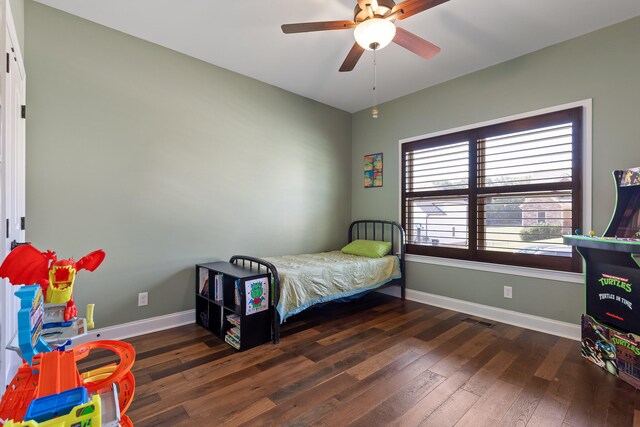 bedroom featuring ceiling fan and dark hardwood / wood-style flooring