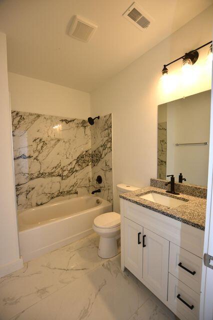 1903 Sharp St, Chattanooga, TN 37404 - bathroom with vanity, toilet, washtub / shower combination, and marble finish flooring
