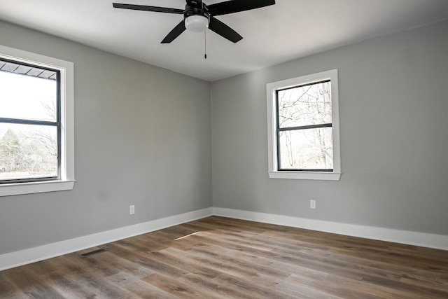 spare room with hardwood / wood-style floors and ceiling fan