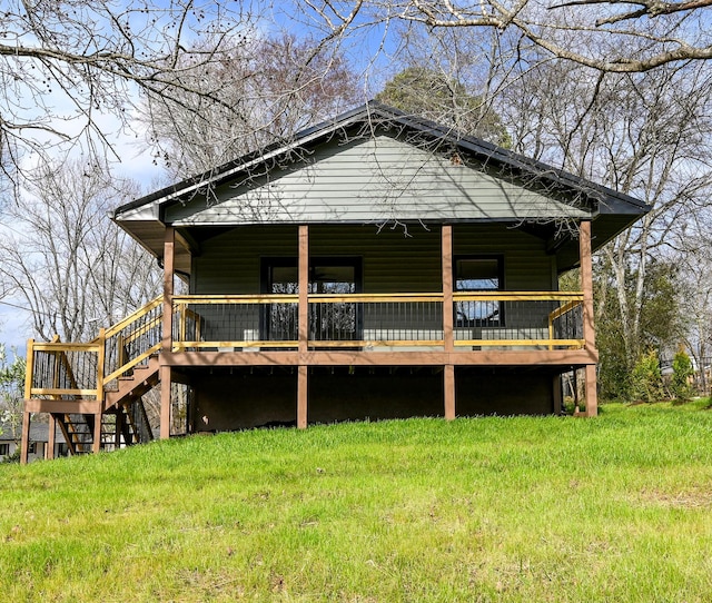 rear view of house featuring a lawn