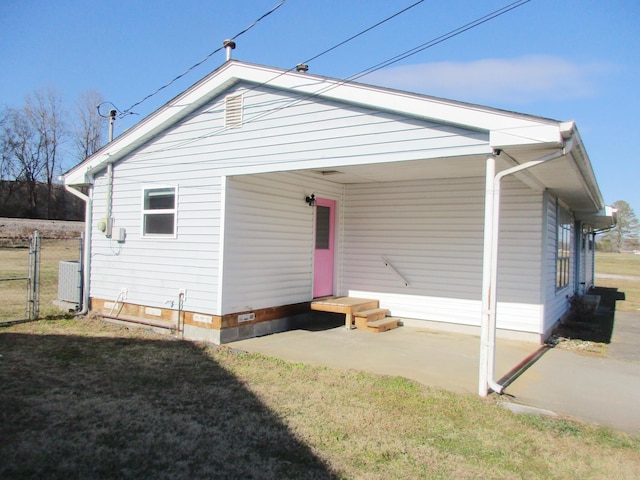 rear view of property with a patio area and a lawn