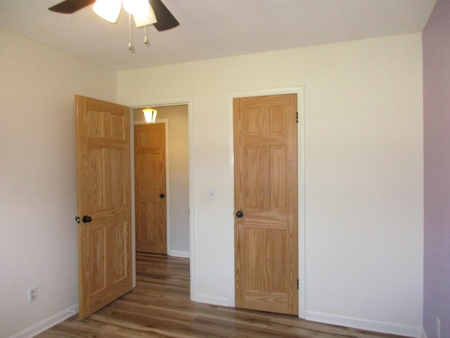 unfurnished bedroom with hardwood / wood-style flooring and ceiling fan