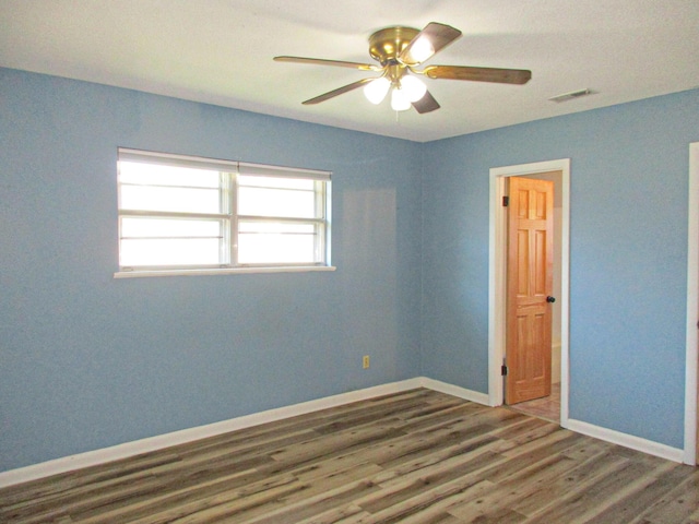 unfurnished room featuring ceiling fan and dark hardwood / wood-style floors