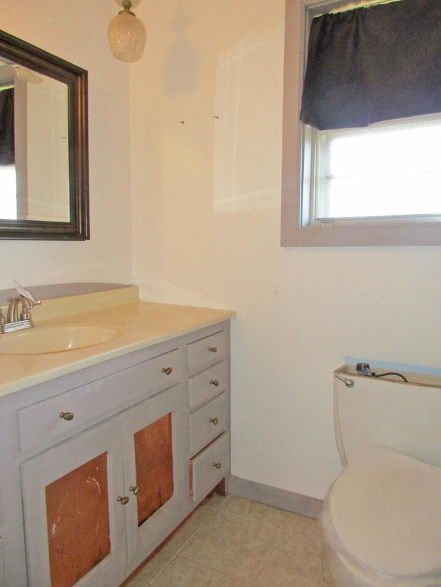 bathroom featuring tile patterned floors, vanity, and toilet