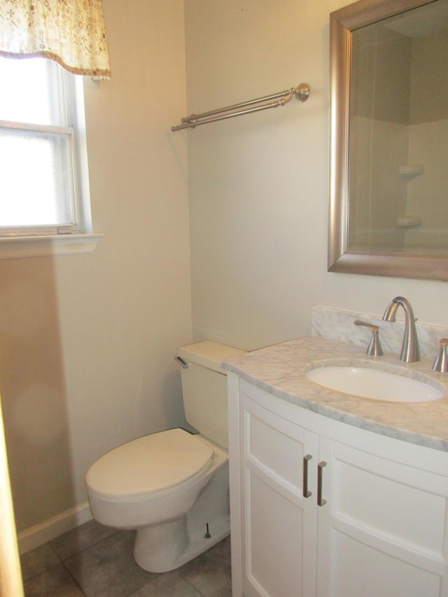 bathroom with vanity, tile patterned floors, and toilet