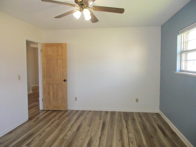 unfurnished room featuring dark hardwood / wood-style floors and ceiling fan