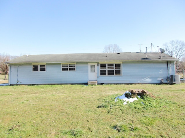 back of house featuring cooling unit and a yard