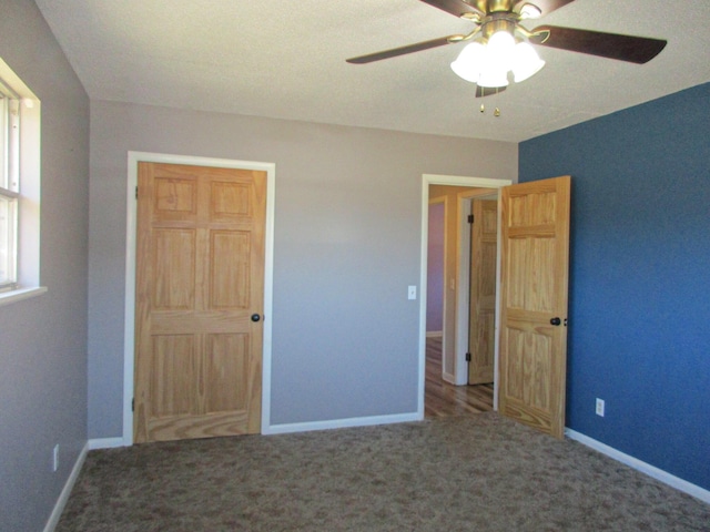 unfurnished bedroom featuring ceiling fan and carpet