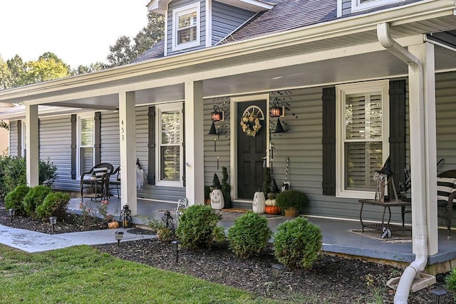 view of exterior entry featuring a porch