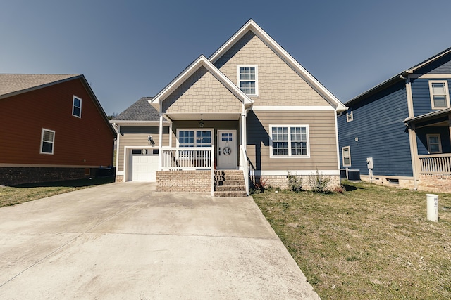 craftsman-style house with a front lawn, a porch, concrete driveway, and a garage