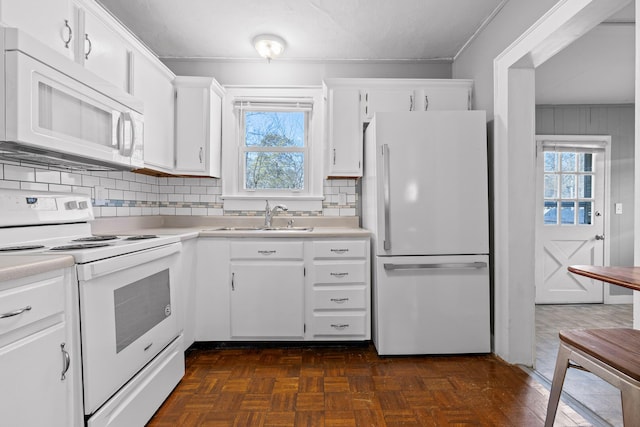 kitchen featuring white cabinetry, sink, white appliances, and plenty of natural light