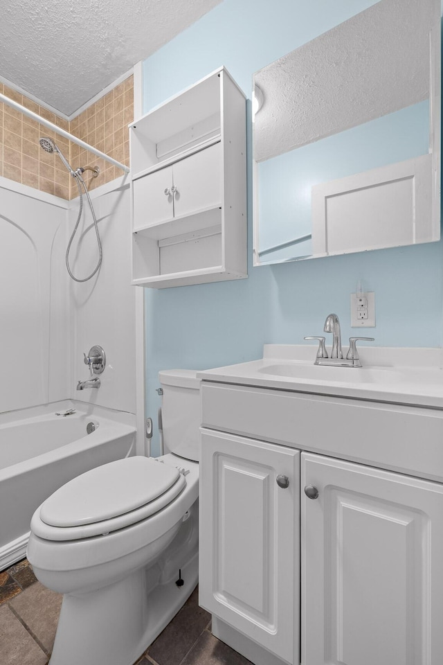 full bathroom featuring vanity, tub / shower combination, a textured ceiling, and toilet