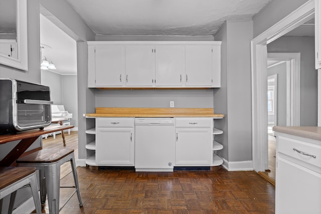 kitchen featuring white cabinetry, dark parquet flooring, and white dishwasher