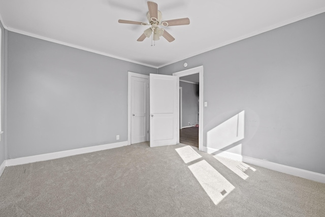 unfurnished room featuring crown molding, carpet floors, and ceiling fan