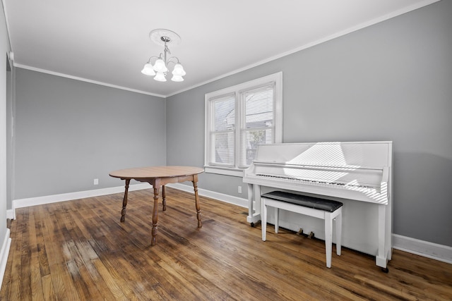 miscellaneous room featuring hardwood / wood-style floors, ornamental molding, and a chandelier