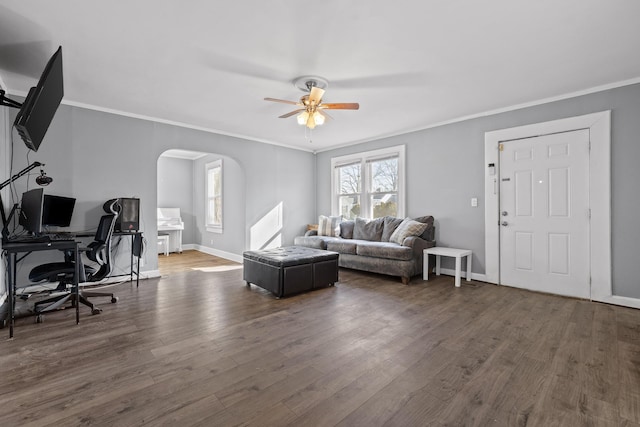 living room with crown molding, ceiling fan, and dark hardwood / wood-style flooring