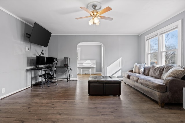 living room with crown molding, ceiling fan, and dark wood-type flooring