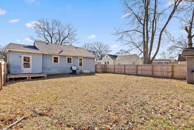 back of property with a lawn