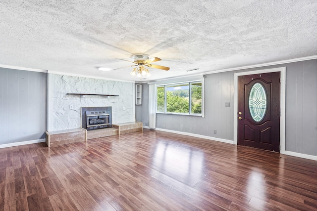 7209 Anthem Trl, Birchwood, TN 37308 - unfurnished living room featuring ornamental molding, wood finished floors, ceiling fan, a stone fireplace, and a textured ceiling