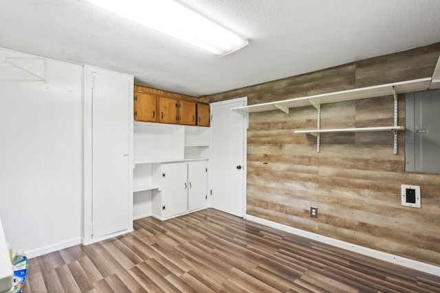 7209 Anthem Trl, Birchwood, TN 37308 - laundry area with wood finished floors, wooden walls, and a textured ceiling