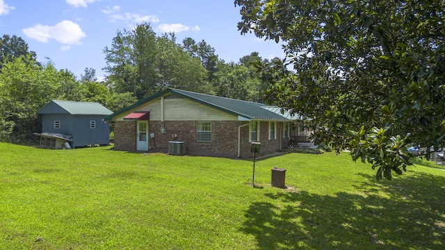 7209 Anthem Trl, Birchwood, TN 37308 - view of home's exterior featuring a lawn, brick siding, and a metal roof