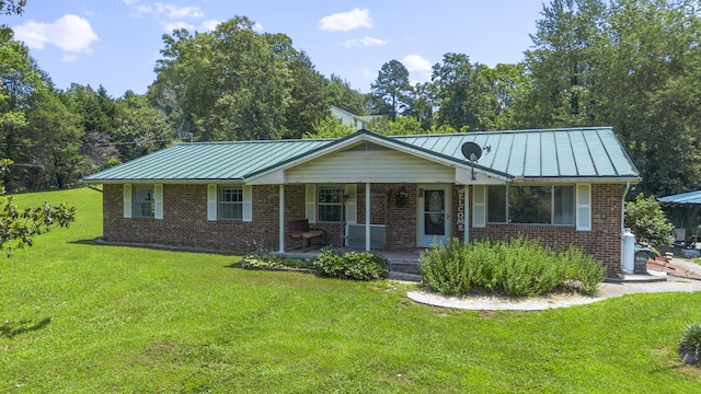 7209 Anthem Trl, Birchwood, TN 37308 - ranch-style house featuring a standing seam roof, covered porch, brick siding, and a front lawn