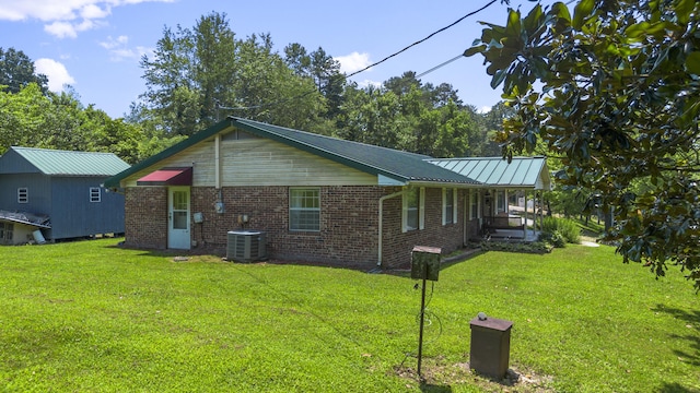 7209 Anthem Trl, Birchwood, TN 37308 - view of side of property featuring a lawn, brick siding, and a metal roof
