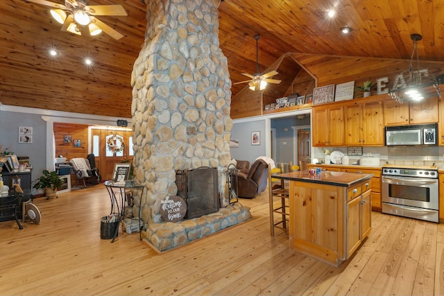 kitchen with a kitchen bar, stainless steel appliances, high vaulted ceiling, wooden ceiling, and a fireplace