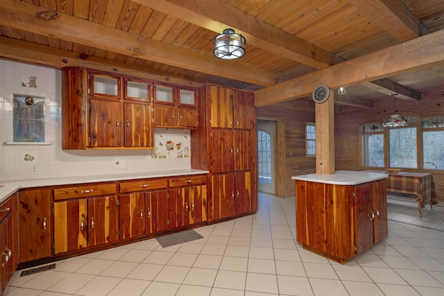 kitchen with wood ceiling, wooden walls, light tile patterned floors, decorative light fixtures, and beamed ceiling