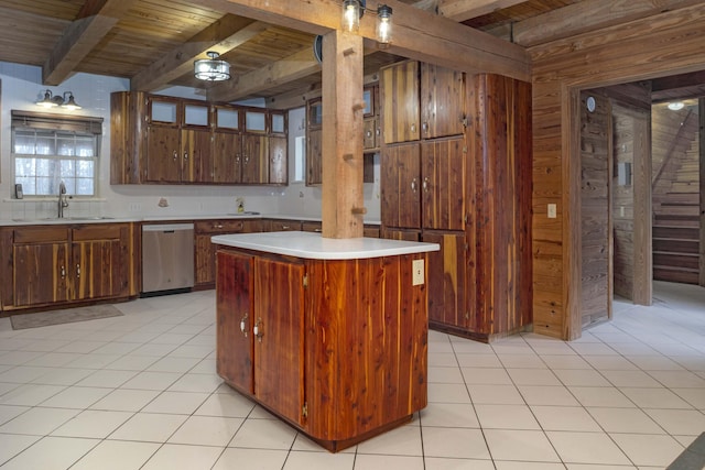 kitchen with beam ceiling, sink, stainless steel dishwasher, wood walls, and a kitchen island